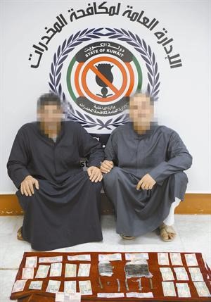 المتهمان وامامهما كمية الحشيش المضبوطة﻿