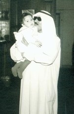 ابراهيم المهيني في شبابه حاملا احد ابنائه