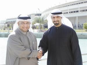فهد رفيع مصافحا محمد الحجيري عقب توقيع الاتفاقية﻿