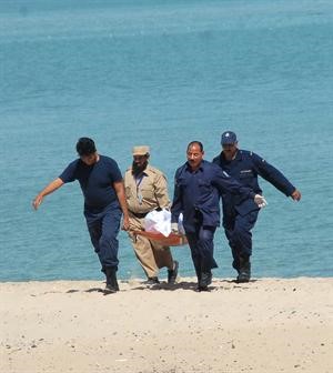 رجال الادلة الجنائية ينقلون الجثة﻿