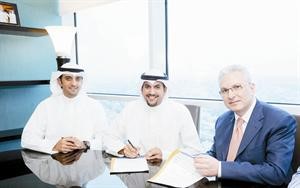 من اليمين جمال عانوتي ومهند الصانع وباسل الجارالله خلال التوقيع على الاتفاقية
