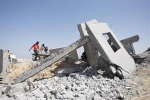 فلسطينيون يتفحصون موقع الدمار الذي خلفته غارات اسرائيلية على رفح جنوب غزة امس الاول افپ