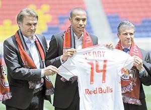 هنري يعرض قميص فريقه الجديد الى جانب رئيس نادي ريدبول ديتمار بيير سدورفر والمدير العام اريك سولر	 افپ﻿