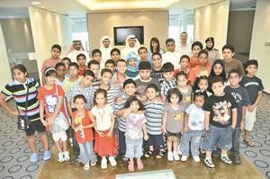 عمر الحوطي وعدد من الموظفين مع مجموعة من الاطفال خلال زيارتهم لـ فيفا
﻿