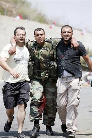 مدنيون لبنانيون يسعفون جنديا اخر