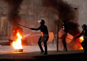 شرطة مكافحة الشغب امام اطارات اشعلها المحتجون في وسط القاهرة امس	رويترز﻿