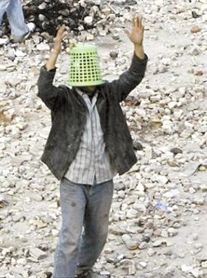 متظاهر يغطي راسه بسلة بلاستيكية﻿