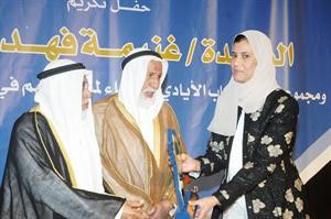 دغيداء تتسلم هدية التكريم نيابة عن غنيمة فهد المرزوق﻿