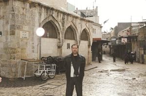 الزميل المحطب امام احد المباني القديمة في القدس الشرقية﻿