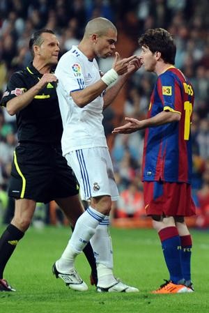 نجم برشلونة ليونيل ميسي في مواجهة مدافع ريال مدريد بيبي وحكم المباراة	افپ﻿