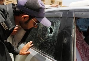 احد المحققين الباكستانيين يعاين السيارة التي اغتيل فيها الديبلوماسي السعودي	اپ﻿