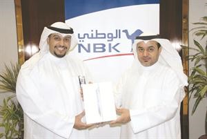 احد الفائزين يتسلم الجائزة من مسؤول العلاقات العامة في بنك الكويت الوطني طلال التركي
﻿
