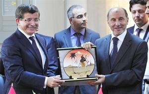 رئيس المجلس الانتقالي مصطفى عبدالجليل يقدم درعا تكريمية لوزير الخارجية التركي احمد داود اوغلو	رويترز﻿