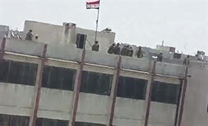 صورة بثها ناشطون لمن قالوا انهم عناصر من الجيش يعتلون سطح احدى المدارس في حمص