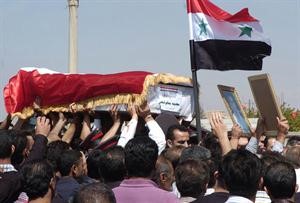 صورة وزعتها سانا لرجال شرطة يشيعون زميل لهم قتل مؤخرا في بلدة القاسمية في السويداء	افپ﻿