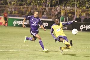 مدافع النصر عمر هوساوي يبعد الكرة امام مهاجم الهلال يوسف العربي