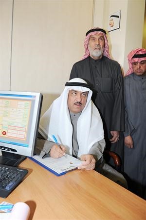 مسلم البراك جالسا وعباس الشعبي يقف خلفه مساندا اثناء تسجيل ترشحه