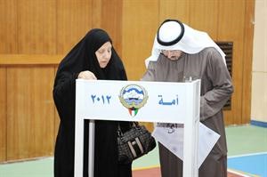 مساعدة احدى الناخبات في تسجيل البيانات
