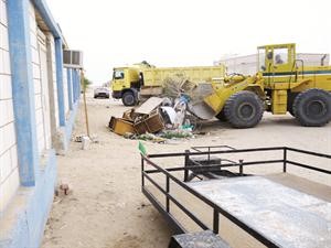 الاليات تزيل بعض المخلفات من احدى المناطق البرية
