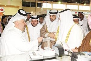 العبدالله يستمع لشرح من احد المشاركين﻿