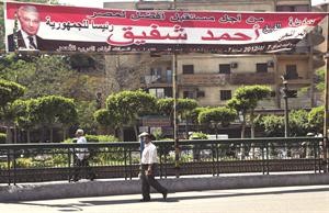 احدى اللافتات التي تؤيد احمد شفيق في الانتخابات الرئاسية قبل صدور قانون العزل السياسي امس الاول	رويترز﻿