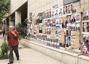حائط ممتلئ بصور المرشحين للانتخابات البرلمانية في دمشق افپ