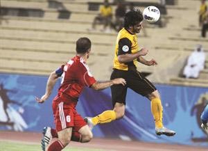 عمر السومة يروض الكرة براسه بمراقبة مدافع الاتحاد السوريهاني الشمري﻿