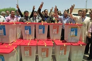 العاملون في لجنة الانتخابات يرددون النشيد الوطني الليبي خلف صناديق اقتراع وردت حديثا من الكفرة الى طرابلس امس ﻿