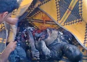 صورة عن فيديو بثه ناشطون لجثة واشلاء ضحايا مجزرة بقرص في دير الزور