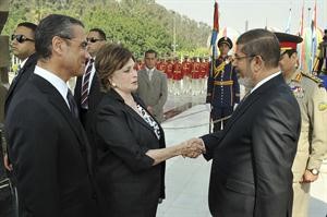 الرئيس المصري د محمد مرسي يصافح جيهان السادات امام قبر الرئيس الراحل خلال الاحتفالات بذكرى حرب اكتوبررويترز﻿