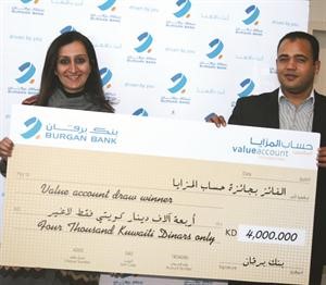 الفائز بالسحب يحمل شيك الجائزة ﻿