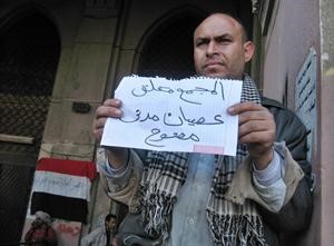 مصري امام مجمع التحرير يرفع لافتة عصيان مدني مفتوح افپ