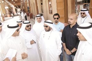 الاعضاء المشاركون في الجولة يستمعون الى الملاحظات حول تطوير الاسواق في المباركية﻿