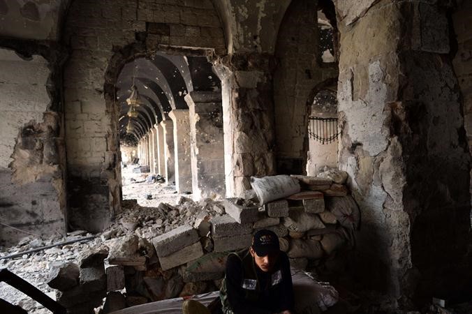 مقاتل من الجيش الحر ياخذ استراحة في احد اروقة المسجد الاموي الاثري في حلب ويبدو الدمار الذي خلفته الاشتباكاتوالقصف العنيف الذي تعرض له افپ
