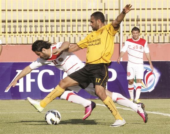 نجم الاصفر بدر المطوع يحاول انتزاع الكرة من لاعب الشرطة	الازرقكوم﻿