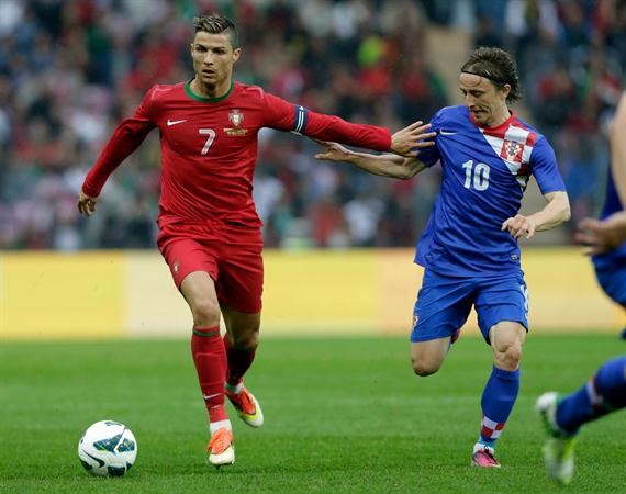 نجم البرتغال رونالدو يمر من زميله في الريال لاعب وسط كرواتيا لوكا مودريتش رويترز
