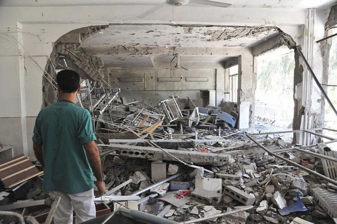 احد الممرضين يعاين الدمار الذي لحق بالمستشفى الوطني في الرقة نتيجة غارة لطيران النظام اول من امسرويترز