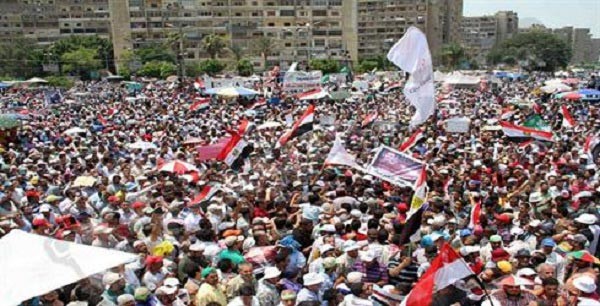 بالفيديو.. مصري يرفع ابنته الرضيعة في رابعة بعد وفاتها مختنقة بالغاز