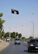 علم تنظيم الدولة الاسلامية في العراق والشام المرتبط بالقاعدة على مدخل مدينة الرقة في شرق سوريةرويترز﻿