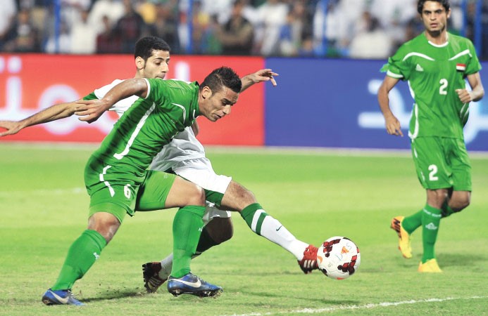 السعودي تيسير الجاسم يخطف الكرة من امام المدافع العراقي علي عدنان لحظة احرازه الهدف الاول افپ