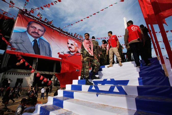 فلسطينيون يطاون العلم الاسرائيلي خلال مسيرة فيالذكرى 46 لتاسيس الجبهة الشعبية	رويترز ﻿