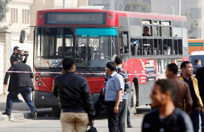 افراد من الامن المصري يقومون بمعاينة الحافلة التي استهدفها التفجير في مدينة نصر بالقاهرة امس رويترز