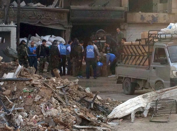 موظفو الاونروا خلال عملية ايصال الاغاثة الى مخيم اليرموك امس الاول افپ
