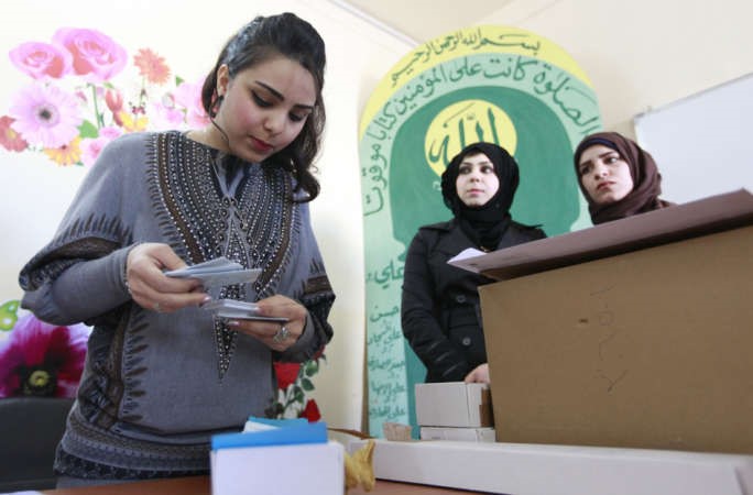 عراقيات يتسلمن بطاقتهن الانتخابية في احد المقار ببغداد امس اب 