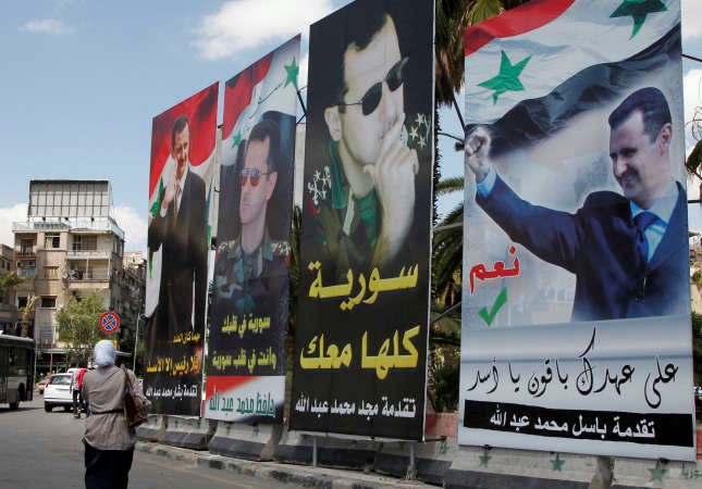 صور الرئيس بشار الاسد تملا شوارع دمشق عشية الانتخابات الرئاسية رويترز 