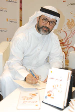 دساجد العبدلي اثناء التوقيع على احدى نسخ الكتاب﻿