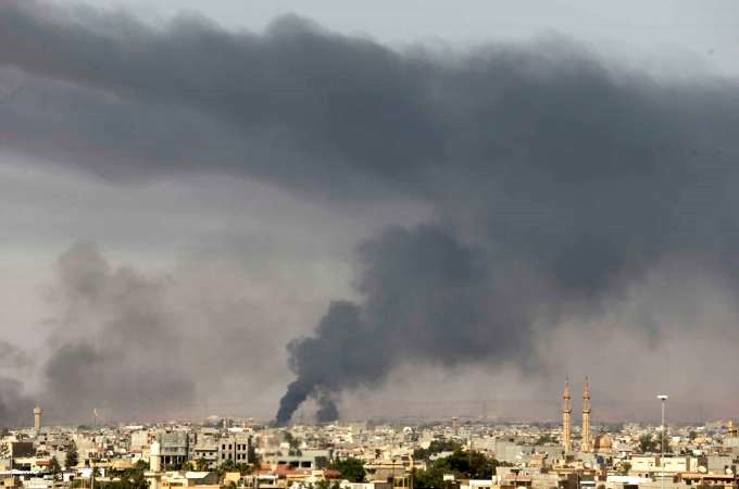 الدخان المتصاعد من خزانات النفط المشتعلة قرب مطار طرابلس	رويترز
﻿