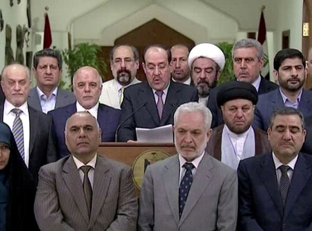 رئيس الوزراء العراقي المنتهية ولايته نوري المالكي يلقي خطاب التنحي وبجواره رئيس الوزراء المكلف حيدر العبادي	 افپ﻿