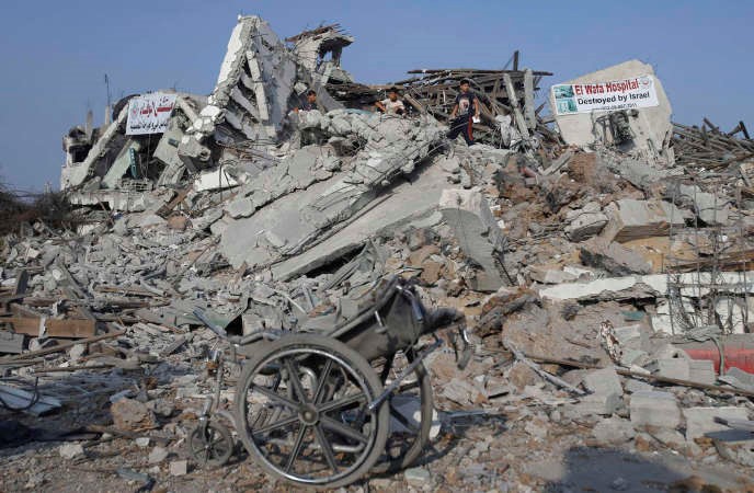 فلسطينيون يعاينون العدوان الذي خلفه العداون الاسرائيلي على مستشفى الوفاء لاعادة التاهيل في غزة	رويترز﻿