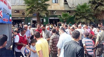 عدد من النازحين السوريين اثناء تسلمهم اضاحي العيد ﻿